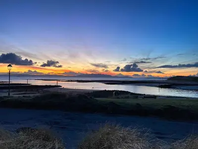 a sunset over a body of water with the sky at Marina Studio in Irvine