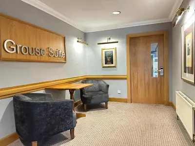 a conference room with a table and two chairs at Hill Park Hotel in Rosyth