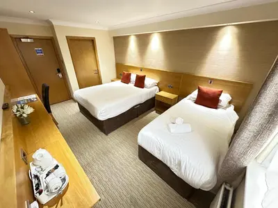 a hotel room with two beds and a camera at Hill Park Hotel in Rosyth