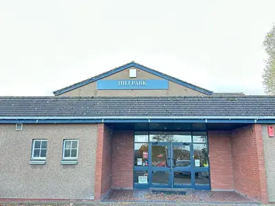 a brick building with a sign that reads hill pharmacy at Hill Park Hotel in Rosyth