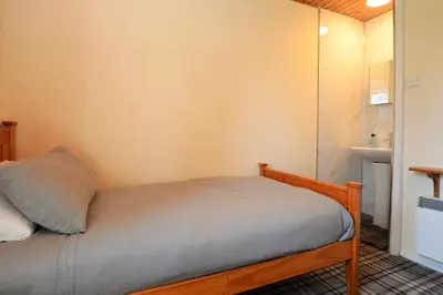 a small bed in a small room at Deer Croft Lodge in Hunters Quay