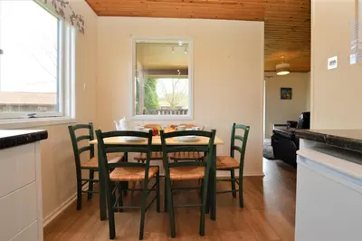 a kitchen and dining room with a table and chairs at Deer Croft Lodge in Hunters Quay