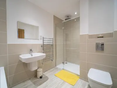 a bathroom with a sink and a toilet and a shower at Taymore Lodge in Kenmore