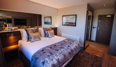 a bedroom with a large bed in a room at The Redhurst Hotel Glasgow in Giffnock