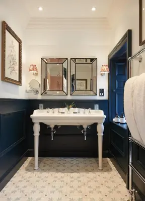 a bathroom with a white sink and two mirrors at Cromlix in Kinbuck