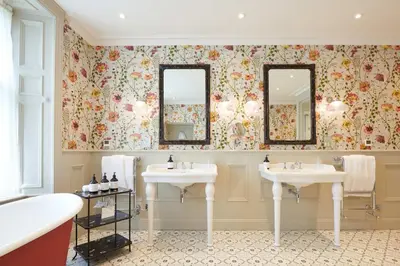 a bathroom with two sinks and two mirrors at Cromlix in Kinbuck