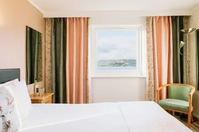 a hotel room with a bed and a window at Muthu Queens Hotel, Oban in Oban