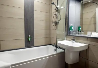 a bathroom with a sink and a bath tub and a sink at Pitbauchlie House Hotel - Sure Hotel Collection by Best Western in Dunfermline