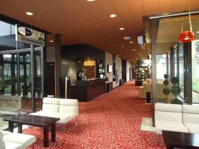 a lobby with white chairs and tables on a red carpet at Pitbauchlie House Hotel - Sure Hotel Collection by Best Western in Dunfermline