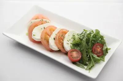 a plate of food with tomatoes and a salad at Argyll Hotel in Dunoon
