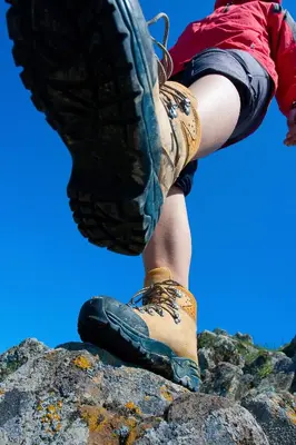 a person sitting on top of a rock in boots at Argyll Hotel in Dunoon