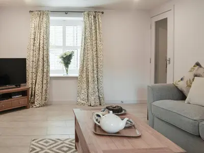 a living room with a couch and a table at Rowanlea in Muthill