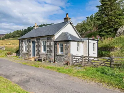 a small cottage on the side of a road at Nettlebush Cottage-Uk5629 in Drummelzier
