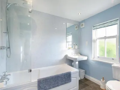a bathroom with a tub and a sink at Nettlebush Cottage-Uk5629 in Drummelzier
