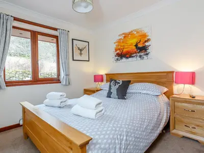 a bedroom with a bed with pillows on it at Ard Taigh in Stron-fearnan