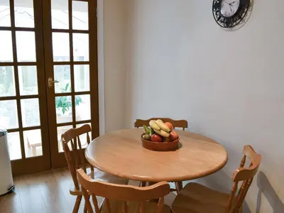 a wooden table with a bowl of fruit on it at Riverside in Kilmelford