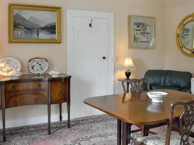 a living room with a table and a couch at The Old Stables in Sorn