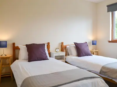 two beds sitting next to each other in a room at Achnaha in Ardentinny