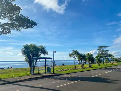 a bus stop on the side of a road at Largs Brisbane Cottage in Largs