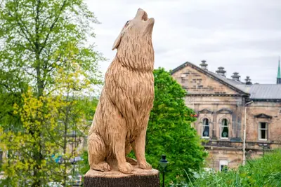 a statue of a dog standing in front of a building at Stirling Youth Hostel in Stirling
