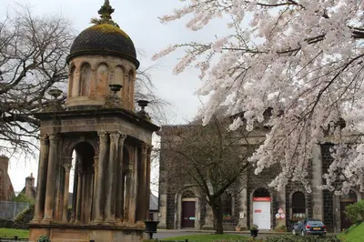 a tower in front of a building with a dome at Stirling Youth Hostel in Stirling