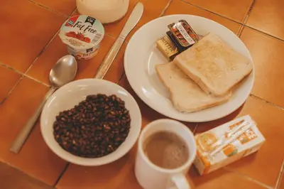 a table topped with two plates of coffee and toast at Stirling Youth Hostel in Stirling