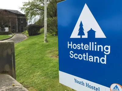 a sign for a housebuilding scotland in front of a yard at Stirling Youth Hostel in Stirling