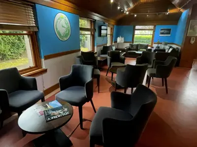 a waiting room in a train with chairs at Stirling Youth Hostel in Stirling