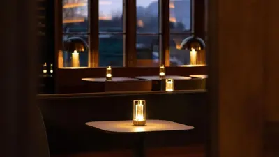 a row of tables in a restaurant with candles at JA Mar Hall Scotland in Bishopton