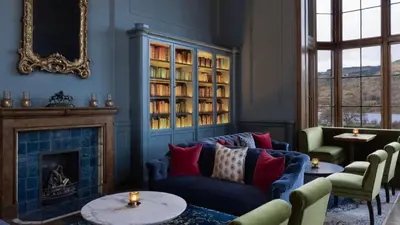 a living room with a couch and a fireplace at JA Mar Hall Scotland in Bishopton