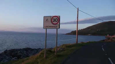 a speed limit sign on the side of a road at Lochranza Youth Hostel in Lochranza
