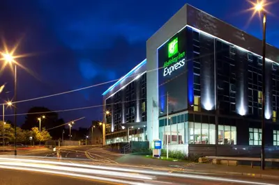 a building with a sign on the side of it at Holiday Inn Express Hamilton by IHG in Hamilton