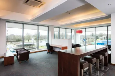 an office with a conference room with a table and chairs at Holiday Inn Express Hamilton by IHG in Hamilton