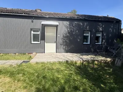a black building with a white door and a patio at Queensferry Guest house in Rosyth