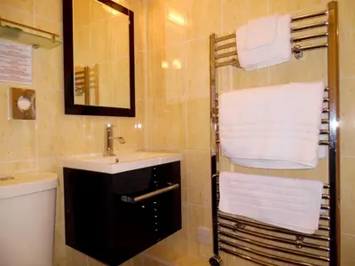 a bathroom with a sink and a toilet and a mirror at Rhins of Galloway in Cairnryan
