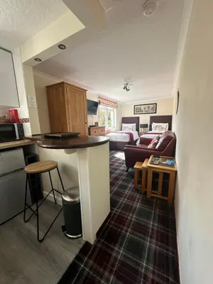 a room with a kitchen and a living room at Beaches in Ayr