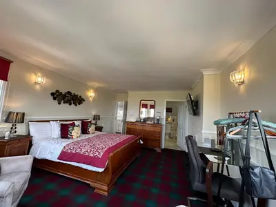 a bedroom with a bed and a bathroom at Beaches in Ayr