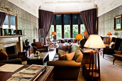 a living room filled with furniture and a fireplace at One Devonshire Gardens a Hotel Du Vin in Glasgow
