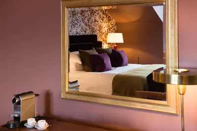 a bedroom with a bed with a large mirror at One Devonshire Gardens a Hotel Du Vin in Glasgow