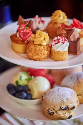 two plates with different types of pastries on them at One Devonshire Gardens a Hotel Du Vin in Glasgow
