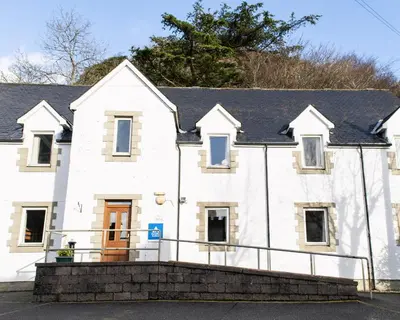 a white house with a black roof at Oban Youth Hostel in Oban