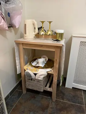 a small wooden table with a microwave on top of it at Retreat at The Knowe Auchincruive Estate in Ayr