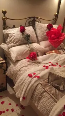 a bed with red roses on top of it at Retreat at The Knowe Auchincruive Estate in Ayr
