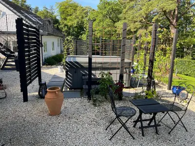 a garden with a table and chairs and a fence at Retreat at The Knowe Auchincruive Estate in Ayr
