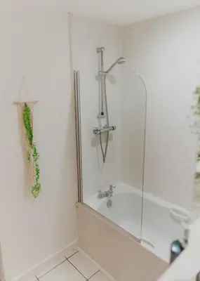 a bathroom with a shower and a bath tub at Lovely Bohemian Apartment in Heart of City Life in Glasgow