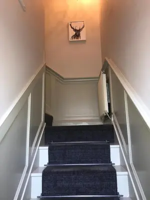 a set of stairs in a house with a picture on the wall at Socair in Callander