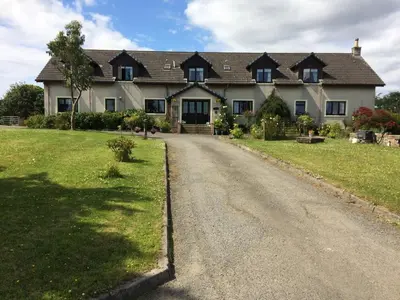 a large house with a road in front of it at Woodcockfaulds House in Stirling