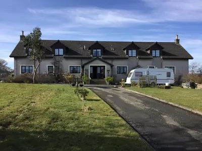 a house with a caravan parked in front of it at Woodcockfaulds House in Stirling
