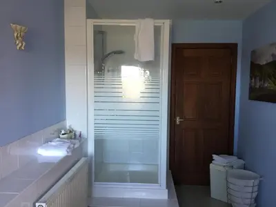 a bathroom with a shower with a glass door at Woodcockfaulds House in Stirling