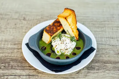 a bowl of soup with bread and cheese on a plate at Sherbrooke Castle Hotel in Glasgow